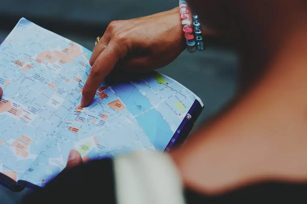 Support for tourism activities, girl reading map